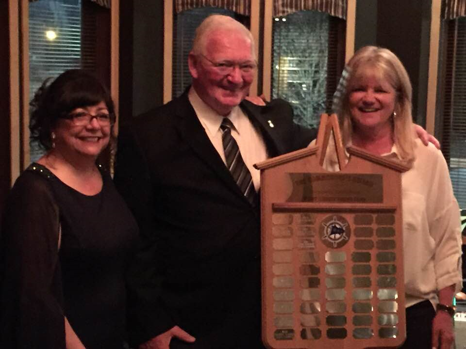 Photo of 3 people receiving an award